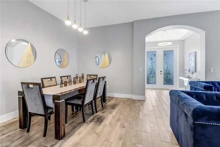 Dining area with light hardwood / wood-style flooring and french doors