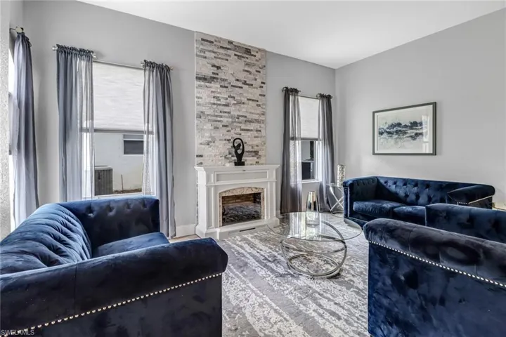 Living room with a fireplace and a healthy amount of sunlight