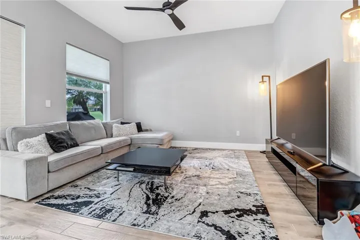 Living room featuring light wood-type flooring and ceiling fan