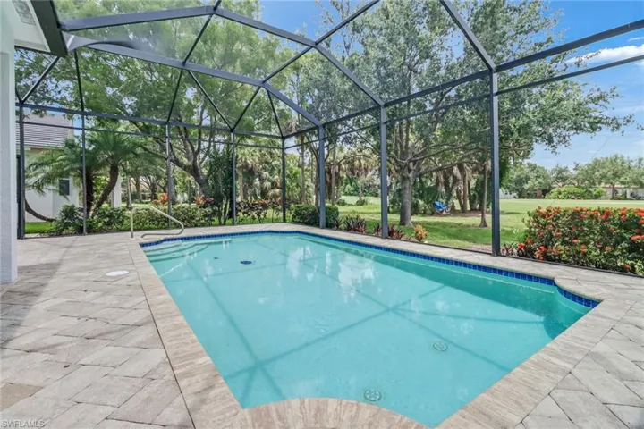 View of swimming pool with a lanai