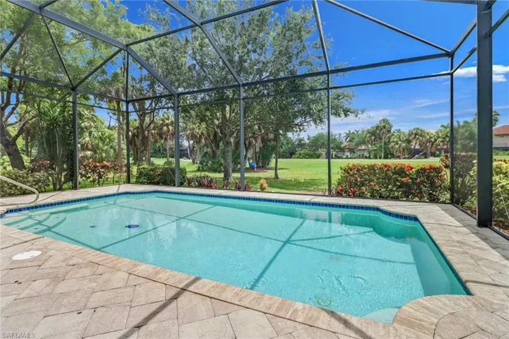 View of pool featuring glass enclosure