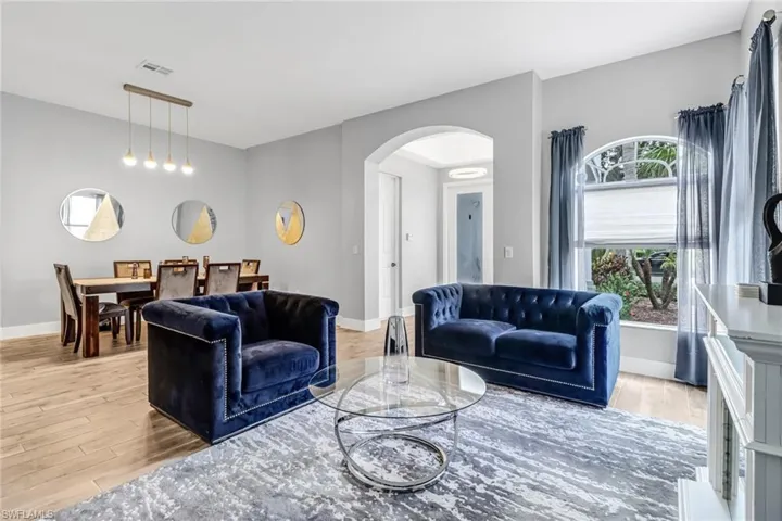 Living room featuring a wealth of natural light and light wood-type flooring