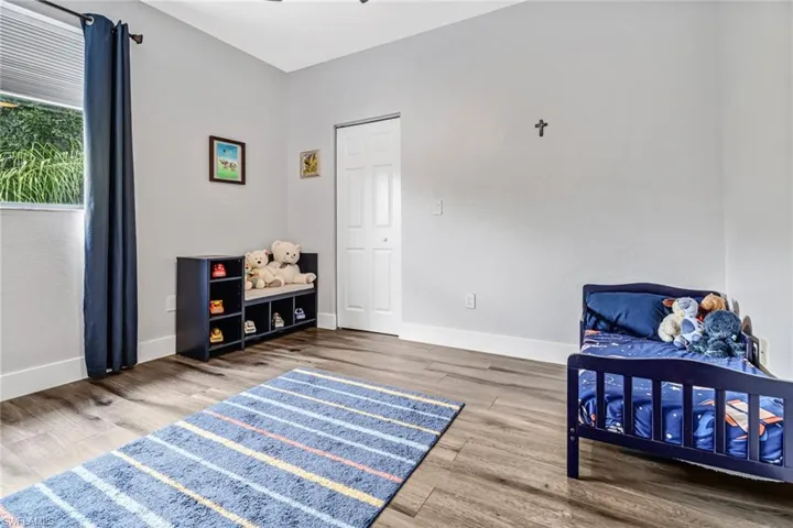 Bedroom with hardwood / wood-style floors