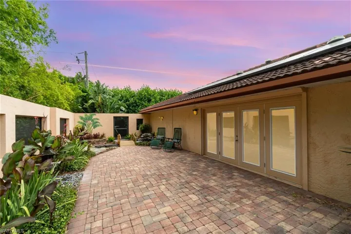 Patio terrace at dusk with french doors