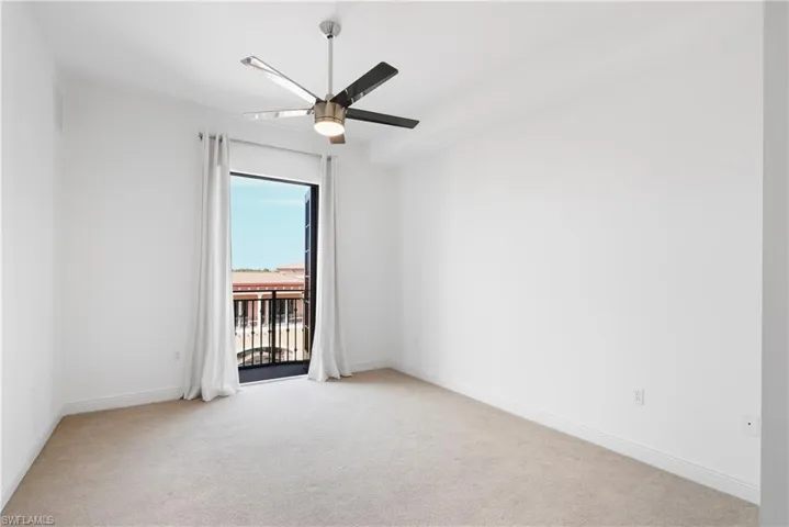 Spare room with light carpet and ceiling fan