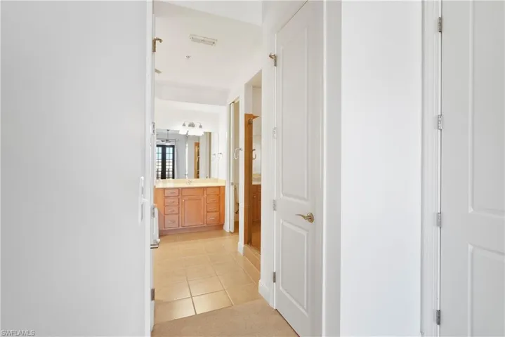Hallway with light tile patterned flooring