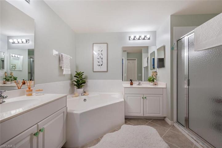 Master bathroom with double sinks, soaking tun and walk in tile shower.