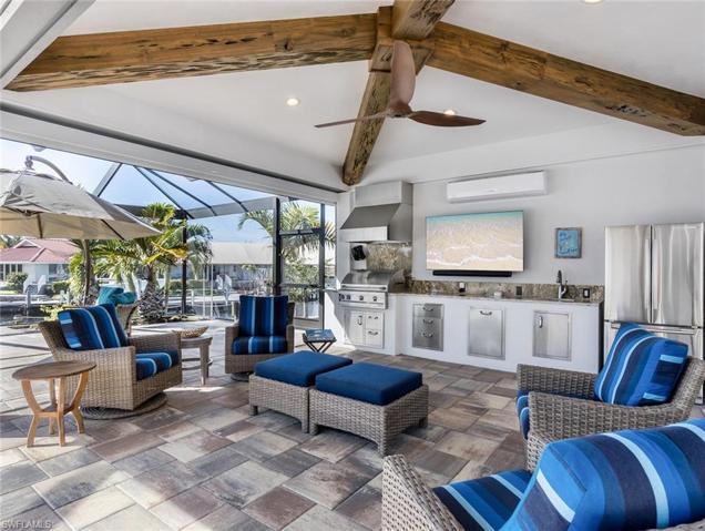 Outdoor living area cabana room complete with kitchen, tv, air conditioner, and roll down shutters!