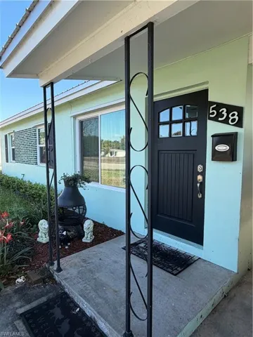 Property entrance with stucco siding