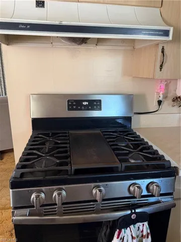 Kitchen view of extractor fan and gas range
