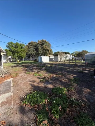 View of yard featuring a storage unit