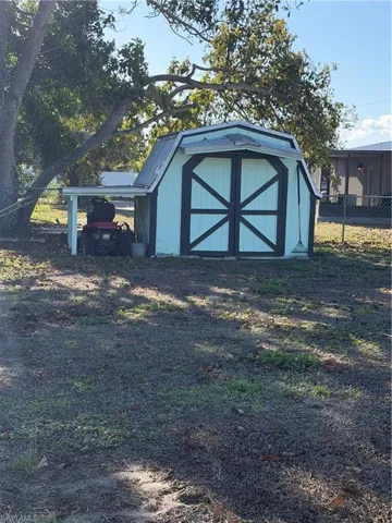 View of shed with a carport