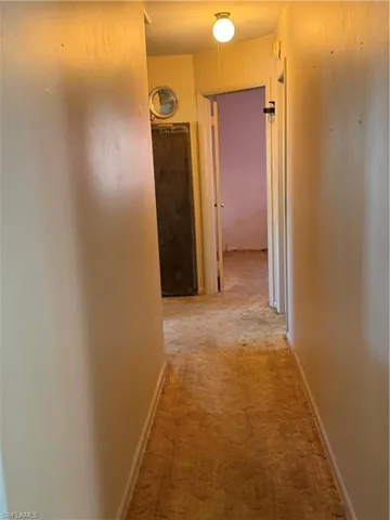 Hall featuring light carpet