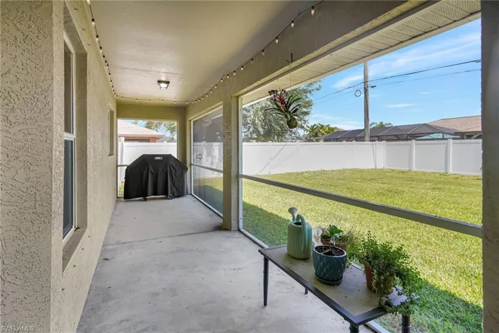 Screened-In Lanai with view of fenced in backyard