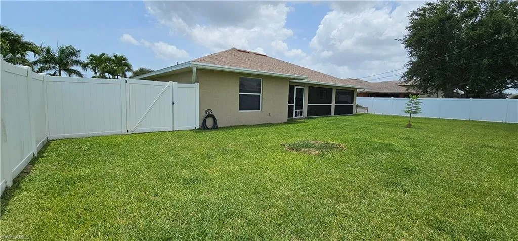 Green, spacious fenced-in backyard