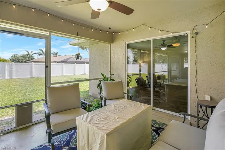 Screened-In Lanai with view of fenced in backyard (sliders lead into Den)