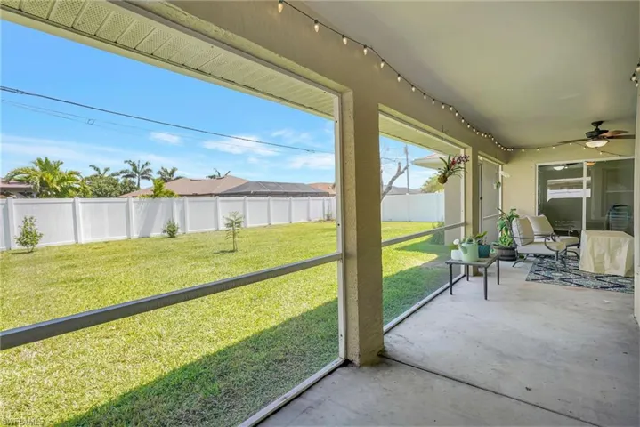 Screened-In Lanai with view of fenced in backyard