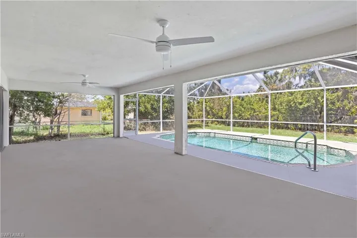 Swimming pool featuring a ceiling fan, a patio, and a lanai