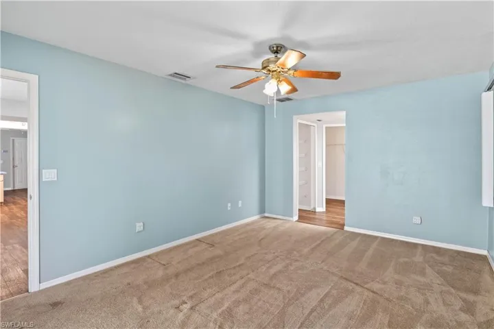 Unfurnished bedroom featuring baseboards, visible vents, and carpet flooring