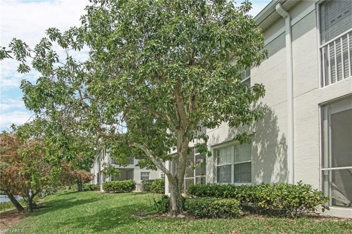 View of home's exterior with a lawn and stucco siding