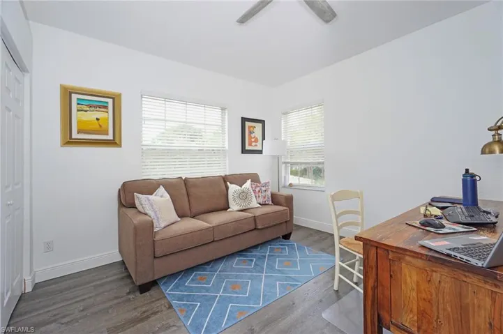 Living room featuring baseboards, ceiling fan, and wood finished floors