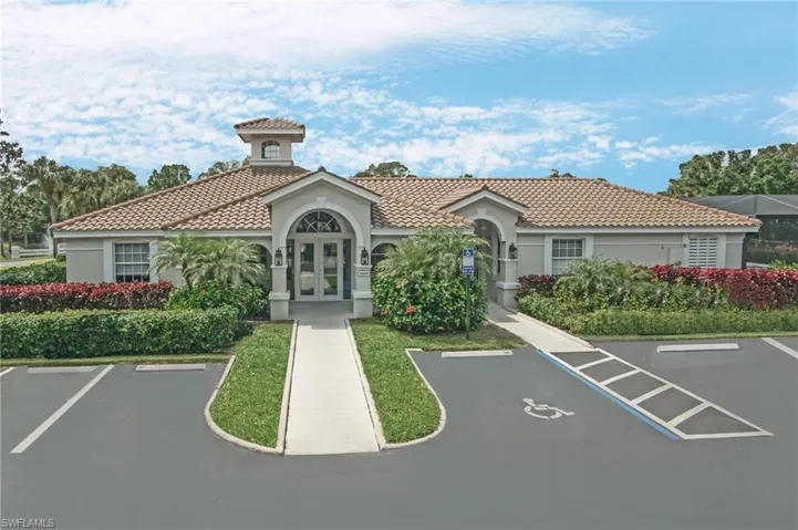 View of building exterior with uncovered parking