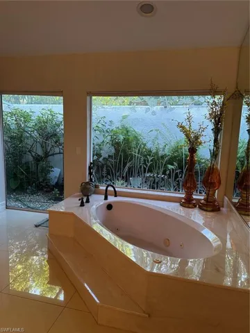 Bathroom featuring tile patterned floors and a jetted tub