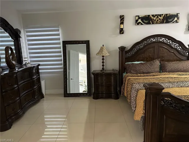 Bedroom with light tile patterned floors and baseboards