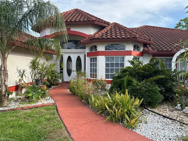 Mediterranean / spanish house with stucco siding and a tiled roof
