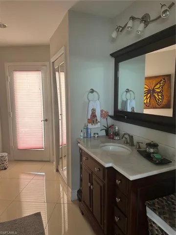 Bathroom featuring tile patterned flooring, vanity, and a stall shower