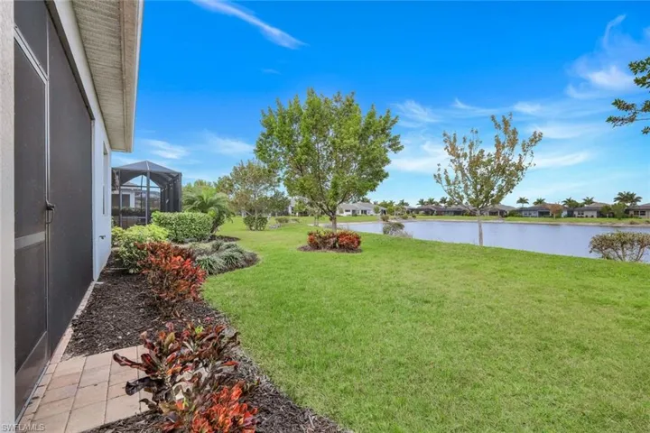 View of grassy yard with a water view