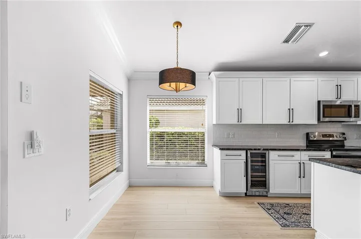 Breakfast nook is light, bright and open to the kitchen and has a nice pool view.