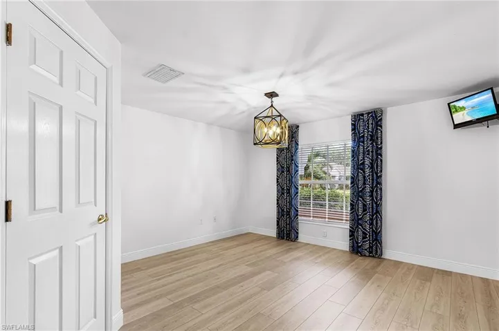 Guest room has a walk-in closet, wood style luxury vinyl floors. This room can also be used as a den.