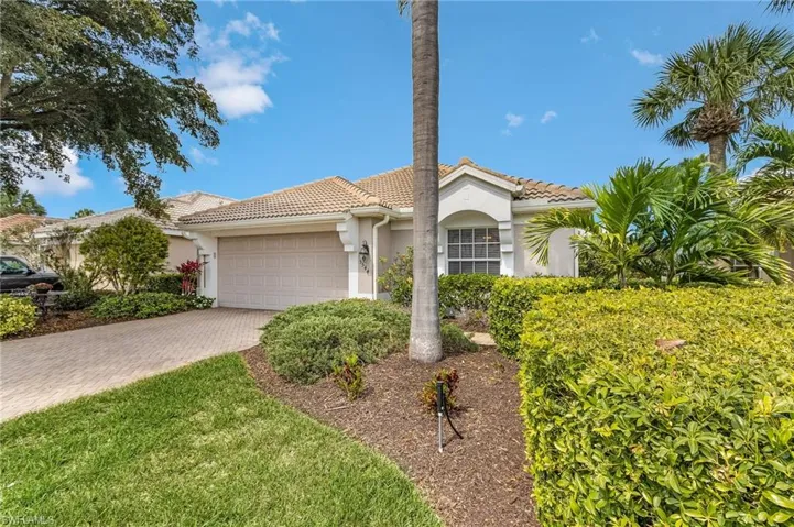 Front of home featuring a newer tiled roof, stucco siding, an attached garage, and decorative paver driveway.