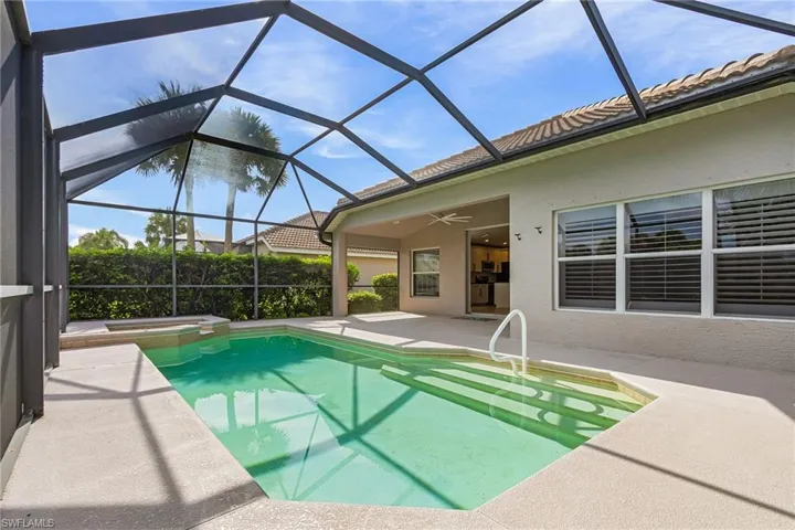 View of swimming pool and hot tub featuring a patio area, ceiling fan and plenty of undercover entertaining space.