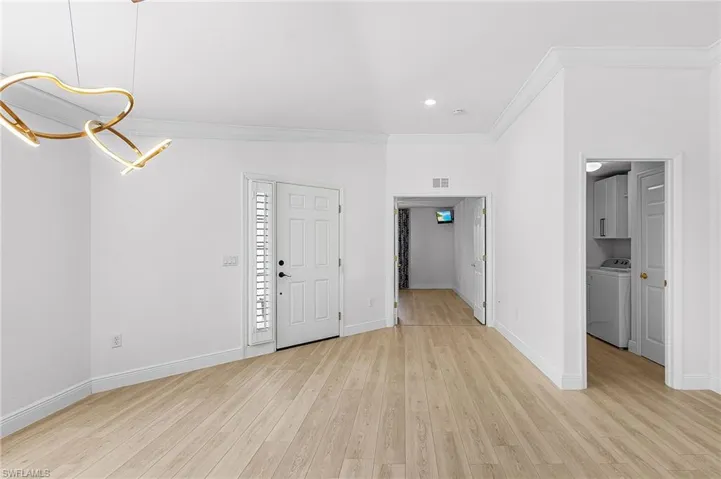 Spacious entry with high ceilings, crown molding, plantation shutters.