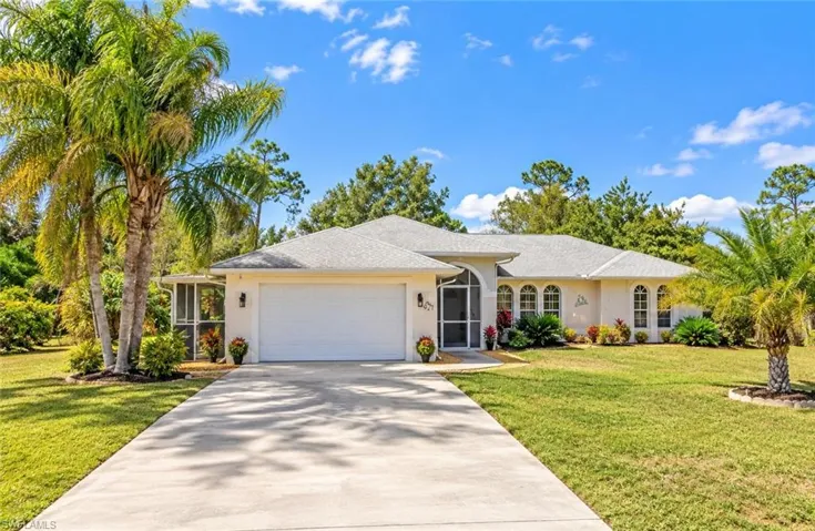 Exterior residence featuring a concrete driveway, attached garage, screened entryway, and a shingle roof