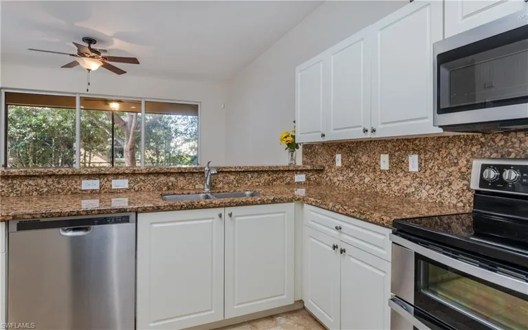 Kitchen featuring appliances with stainless steel finishes, tasteful backsplash