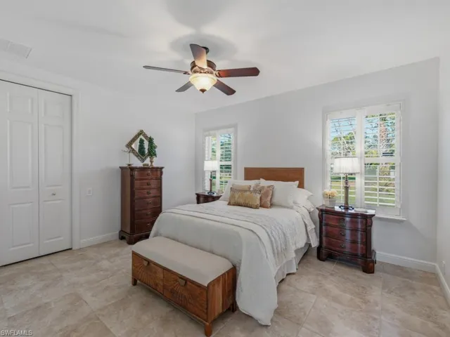 Bedroom with ceiling fan and a closet