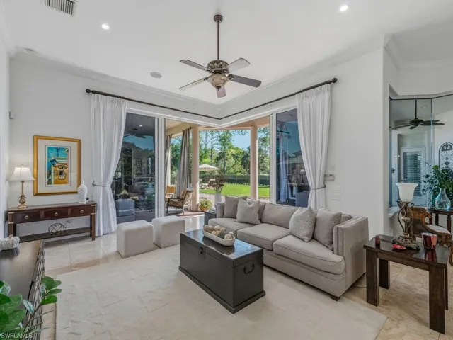 Living room with ceiling fan, ornamental molding, and recessed lighting