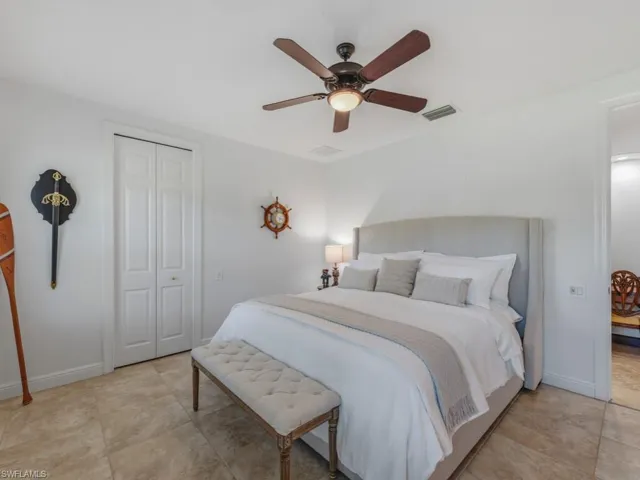 Bedroom with ceiling fan and a closet