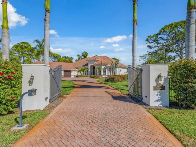 Mediterranean / spanish-style home featuring a gate, a fenced front yard, and stucco siding