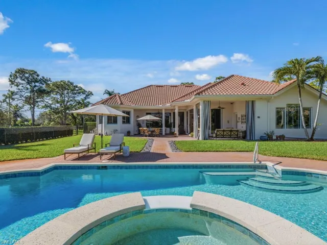 View of swimming pool with a patio area, a pool with connected hot tub, and outdoor dining space