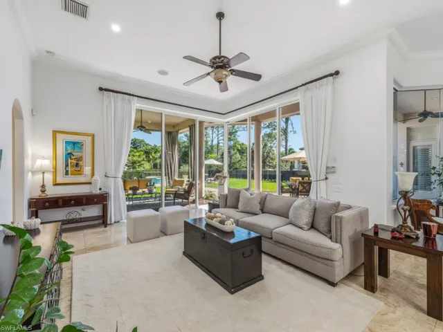 Living room with ceiling fan, crown molding, healthy amount of natural light, arched walkways, and recessed lighting