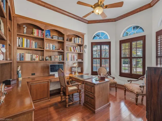 Office with a ceiling fan, dark wood finished floors, and ornamental molding