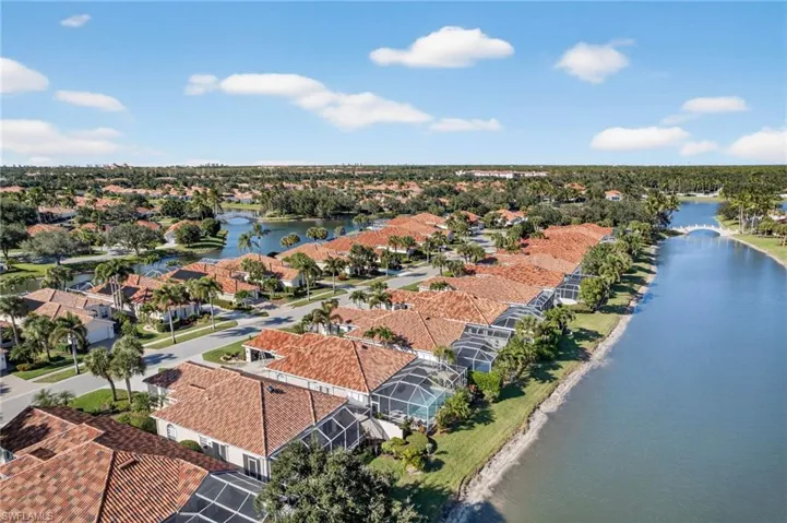 Aerial perspective of suburban area featuring a large body of water