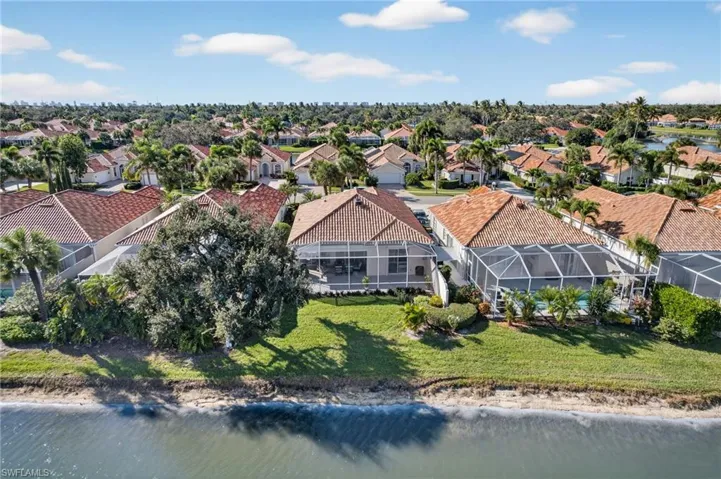 Aerial perspective of suburban area with a nearby body of water