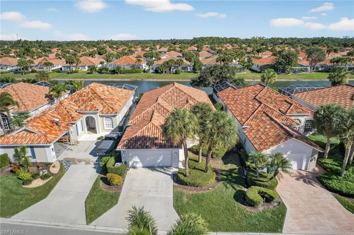 Aerial perspective of suburban area featuring a large body of water