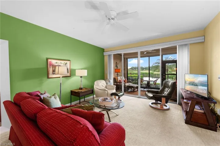 Living room featuring carpet and ceiling fan
