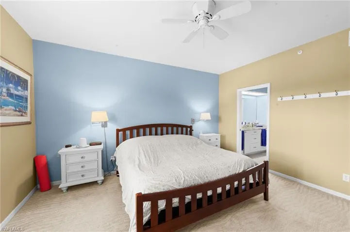 Carpeted bedroom featuring baseboards and a ceiling fan